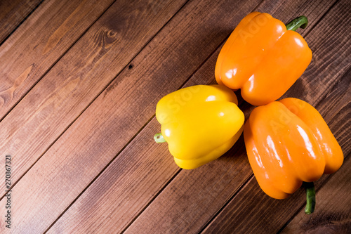 Colorful fresh paprika on a dark wooden table