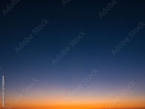 Beautiful gradient sky at dusk, from dark blue to orange © Barry