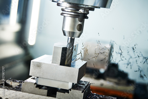 milling cnc machine at metal work industry. Multitool precision machining. Shallow depth of view on shavings photo