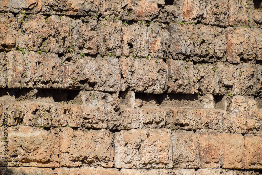 The wall near the gate of Hadrian, the texture of the stone walls of ancient stone blocks.
