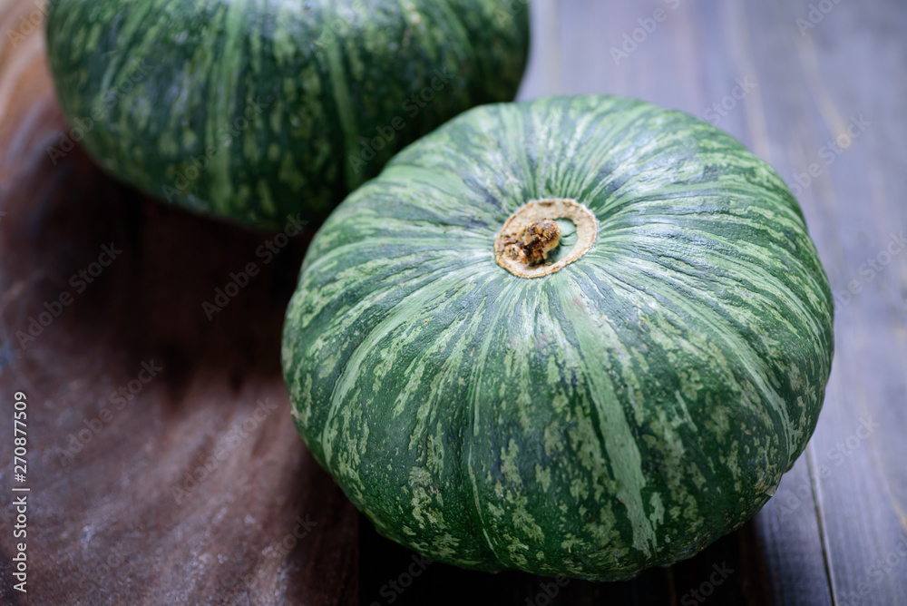 Green pumpkins on wooden background, organic vegetable Green pumpkins on wooden background, organic vegetable