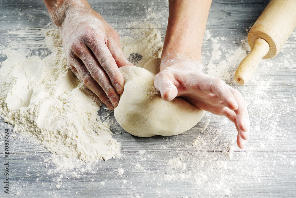 Cook hands knead the dough.Close-up.
