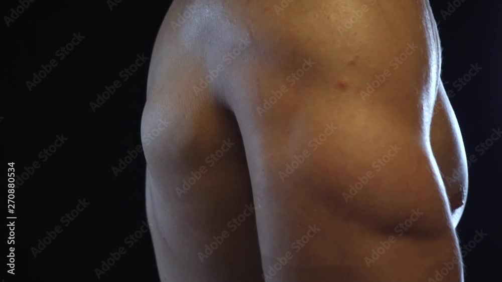 Young fit guy posing, showing showing triceps, slow motion Young fit guy posing, showing showing triceps, slow motion