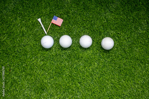 Golf balls with flag of America on green grass