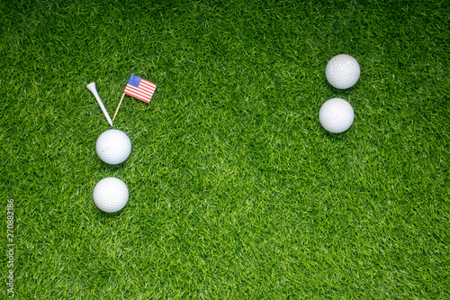 Golf balls with flag of America on green grass