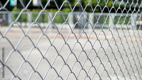 Close up the grid of a metal fence in Sports street park