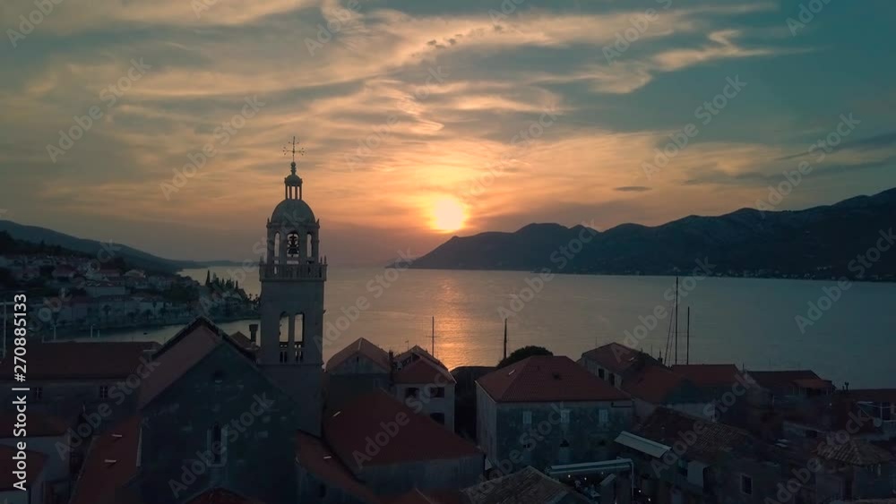 Beautiful sunset in Korcula, Croatia with drone flying over the city towards St. Mark Cathedral Beautiful sunset in Korcula, Croatia with drone flying over the city towards St. Mark Cathedral