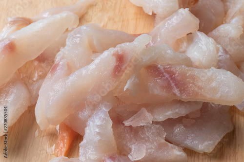 close up of frozen pangasius dory on wooden plate photo