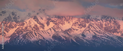 Pink light of dawn on the mountain tops
