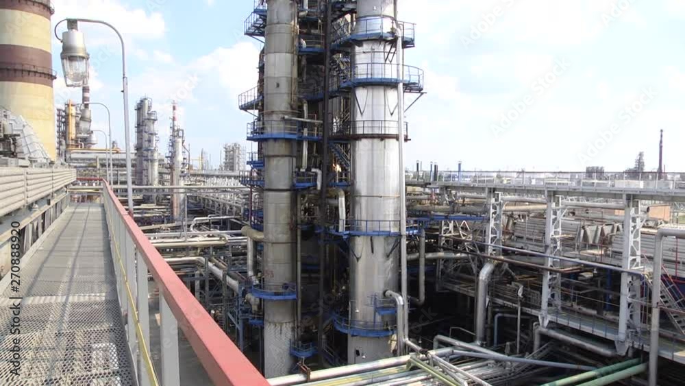 Oil refinery industry. View from the platform to the factory. Refined chimney pipe of a petrochemical oil plant. catalyst, factory. Industrial zone, The equipment of oil refining.