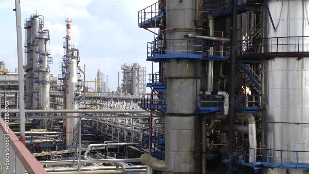 Oil refinery industry. View from the platform to the factory. Refined chimney pipe of a petrochemical oil plant. catalyst, factory. Industrial zone, The equipment of oil refining. Oil refinery industry. View from the platform to the factory. Refined chimney pipe of a petrochemical oil plant. catalyst, factory. Industrial zone, The equipment of oil refining.
