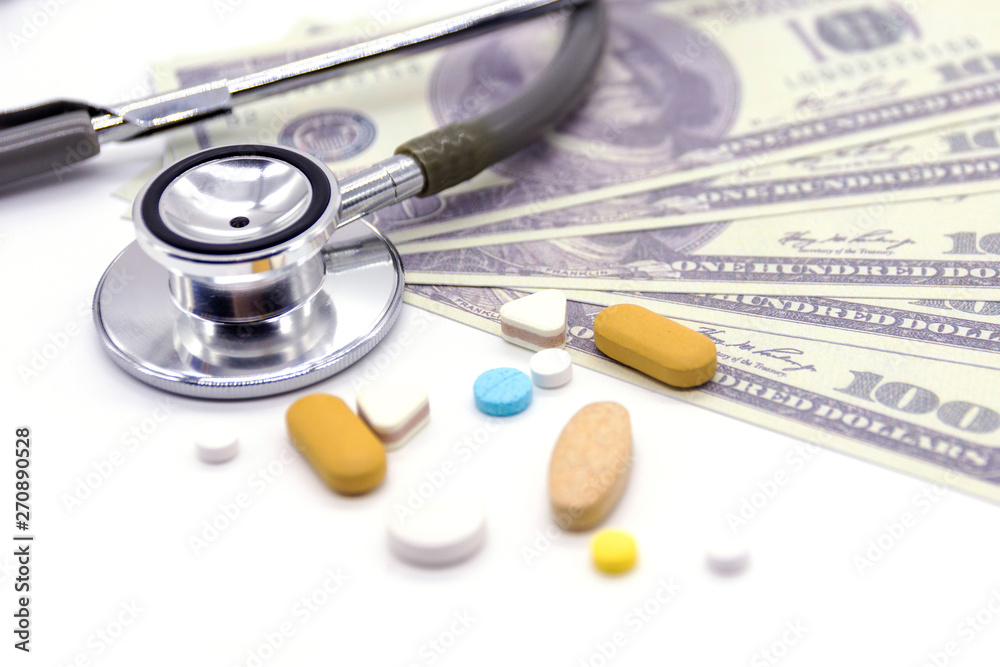 Stethoscope with dollar bank and medicine capsules on white background. healthy lifestyle with business finance concept Stethoscope with dollar bank and medicine capsules on white background. healthy lifestyle with business finance concept