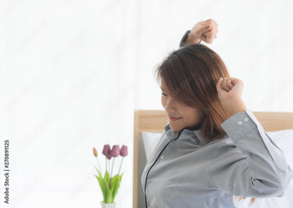 Young beauty asian woman wake up and stretching oneself in bedroom Young beauty asian woman wake up and stretching oneself in bedroom