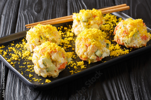 Recipe Gamja Saelleodeu Korean potato salad with eggs, carrots, cucumbers and apples closeup. horizontal photo
