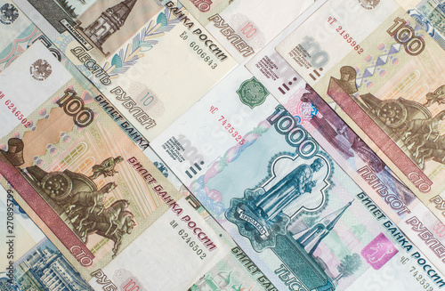 Money. Russian rubles. Notes in denominations of five, ten, fifty, one hundred, five hundred and a thousand rubles. Cash. Background texture.