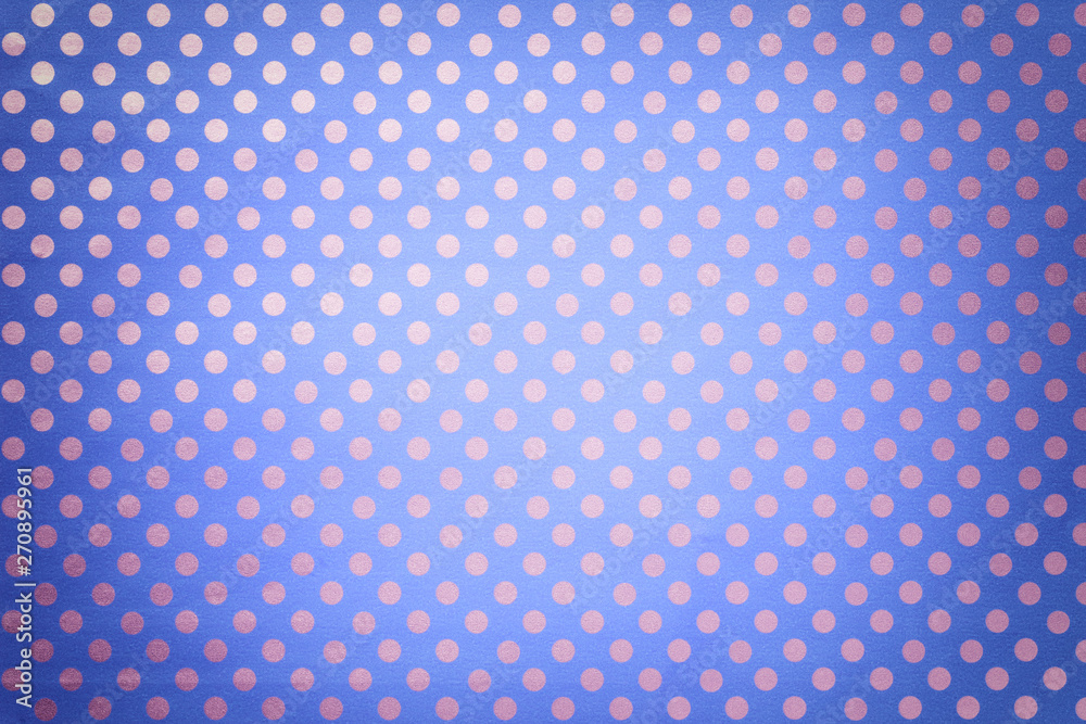 Light blue background from wrapping paper with a pattern of silver polka dot closeup.
