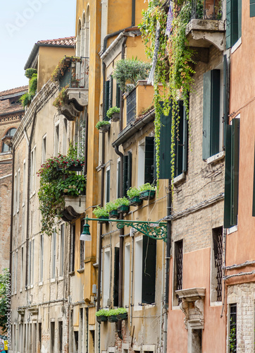 Frasad of a Venetian bricked house with authentic windows and lians on them photo