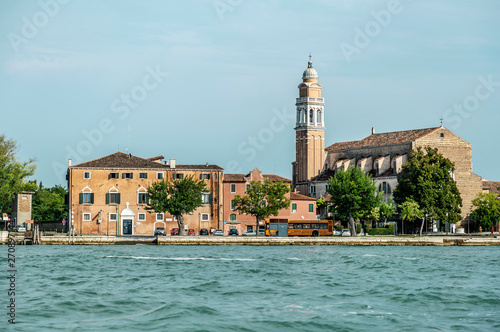 A typical, picturesque and colorful view on the historic center of Venice, Italy with emerald green water