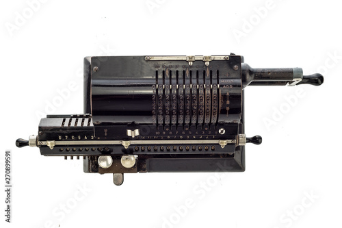 Ancient pinwheel mechanical calculator.The calculating machine, is a mechanical device used to perform automatically the basic operations of arithmetic, rendered obsolete by electronics calculators. photo