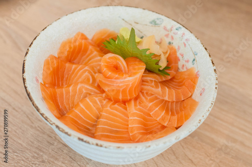 Salmon Don : Japanese rice with a lot of salmon in Japanese ceramic bowl put on the table