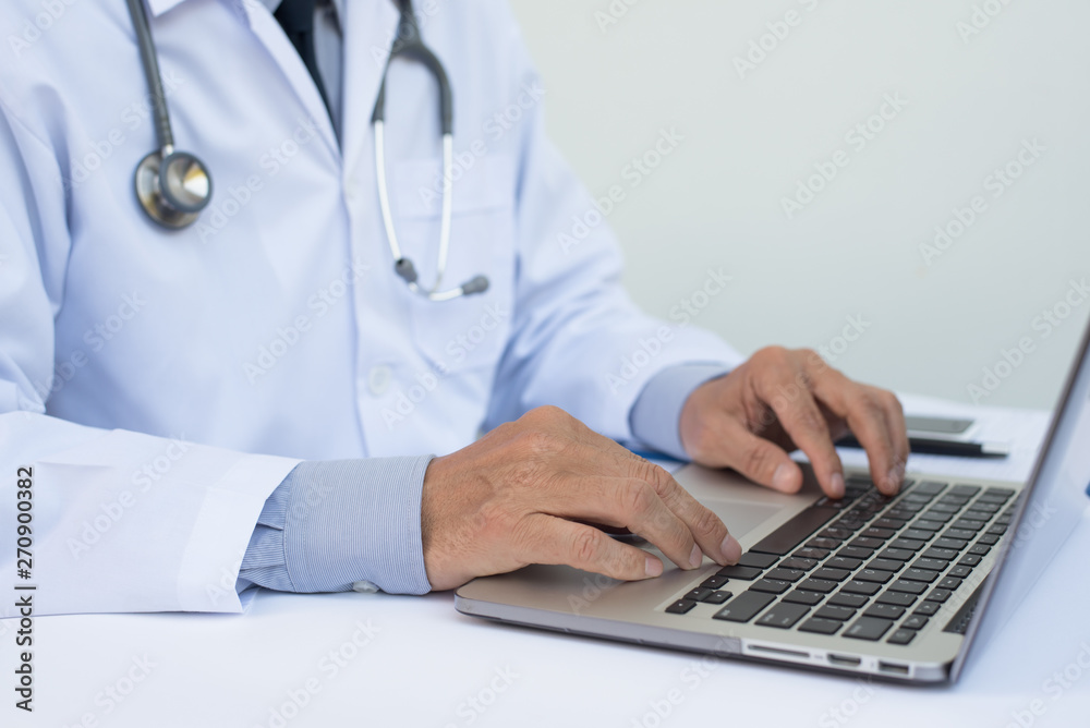 Doctor working on laptop computer Doctor working on laptop computer
