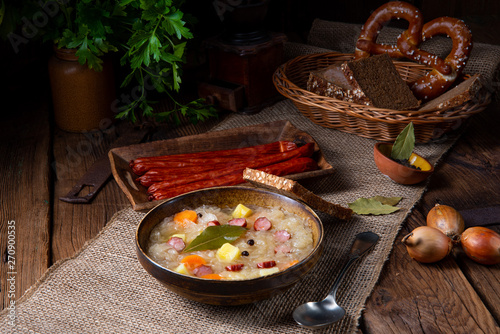 rustic sauerkraut soup with bacon and sausage photo