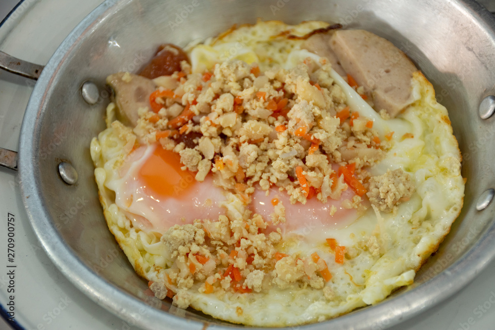 Food set of breakfast pan-fried egg with toppings at local restaurant at morning time in Udon Thani, Thailand