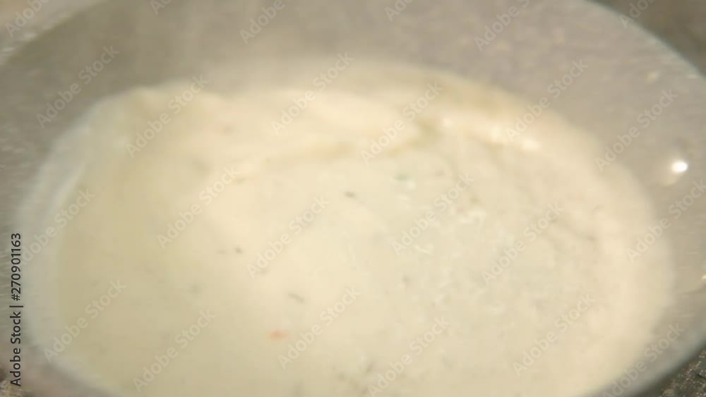 Cooking recipe. Seasoning and spices. Chef mixing white cream sauce in ceramic pan Cooking recipe. Seasoning and spices. Chef mixing white cream sauce in ceramic pan