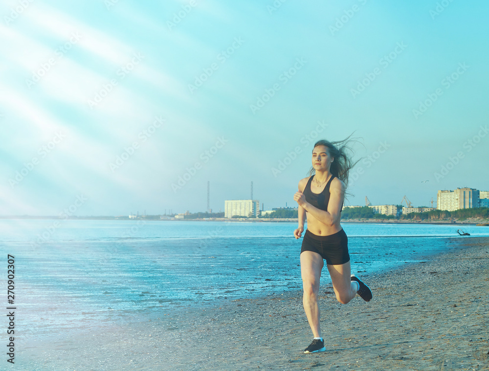 Woman jogging at evening beach