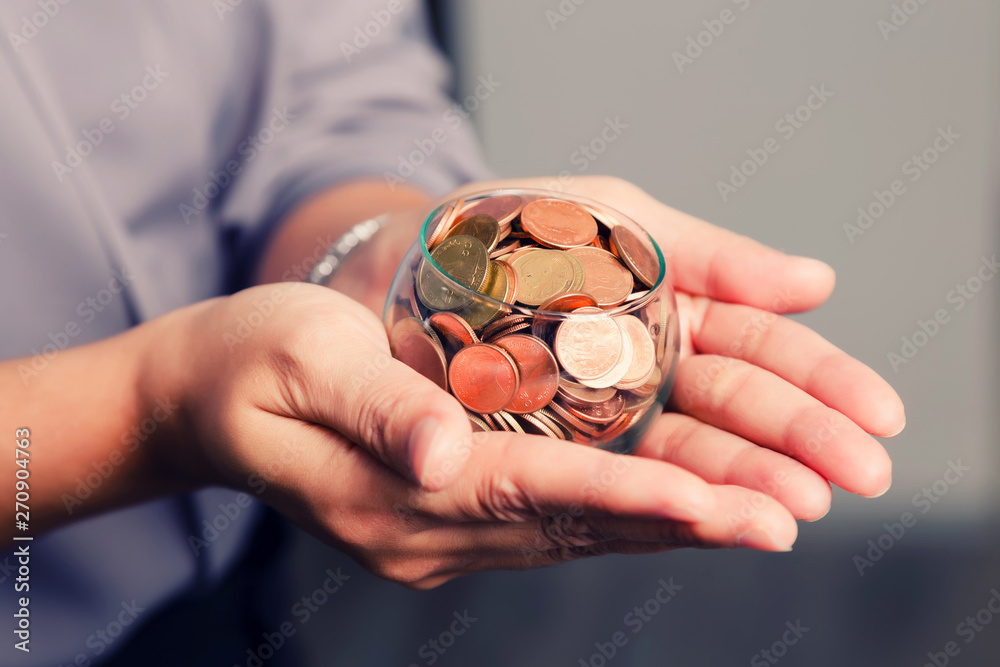 Fototapeta premium coins in hands. saving money concept