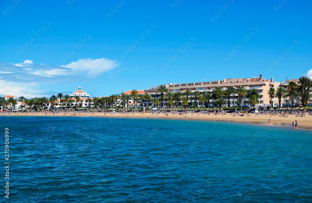 View of Playa del Camison beach with turquoise water and yellow sand in Las Americas, Tenerife,Canary Islands,Spain.Summer vacation or travel concept.