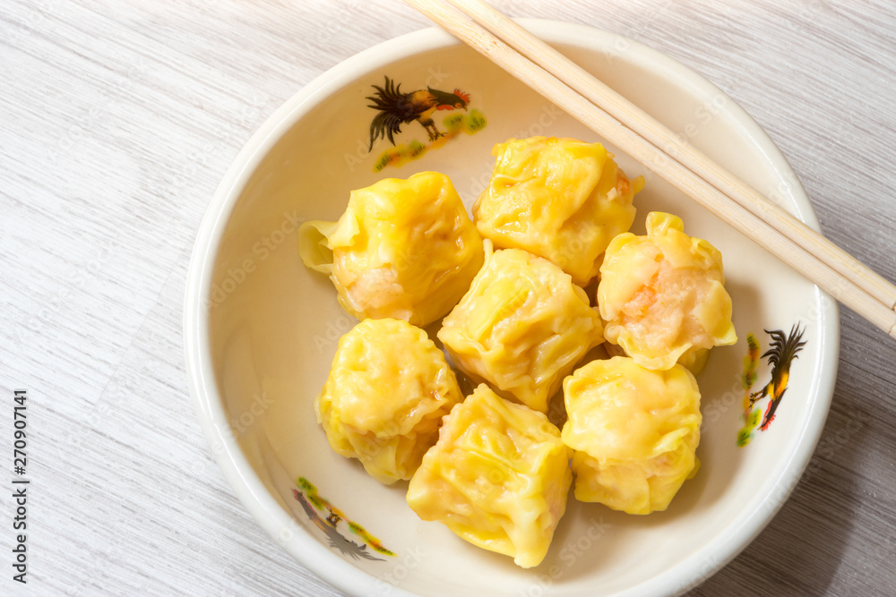 Close up Siu Mai / Dim sum - Chinese steamed shrimp dumplings. Close up Siu Mai / Dim sum - Chinese steamed shrimp dumplings.