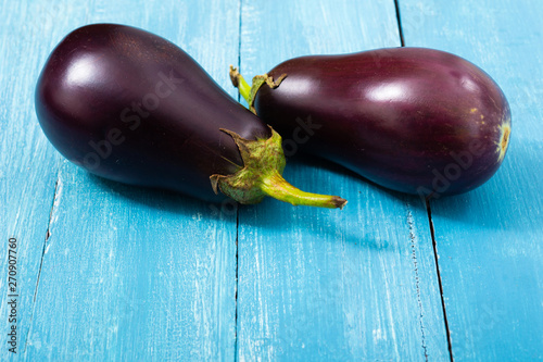 two eggplants on blue wood table