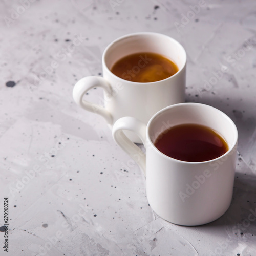 Masala tea in white minimalist cups on a gray table