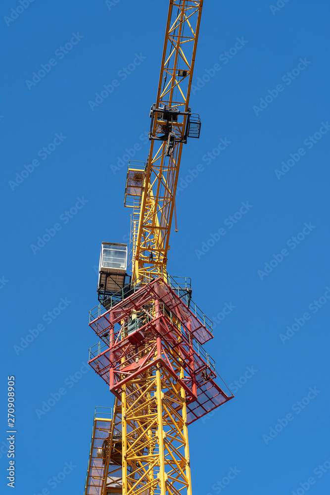 yellow crane and blue sky on building site
