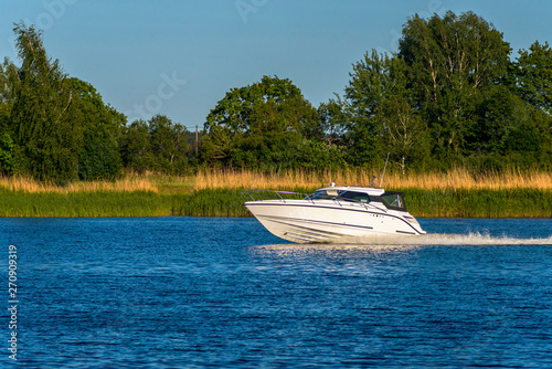 Modern motorboat in a river, summer, Europe © sergei_fish13