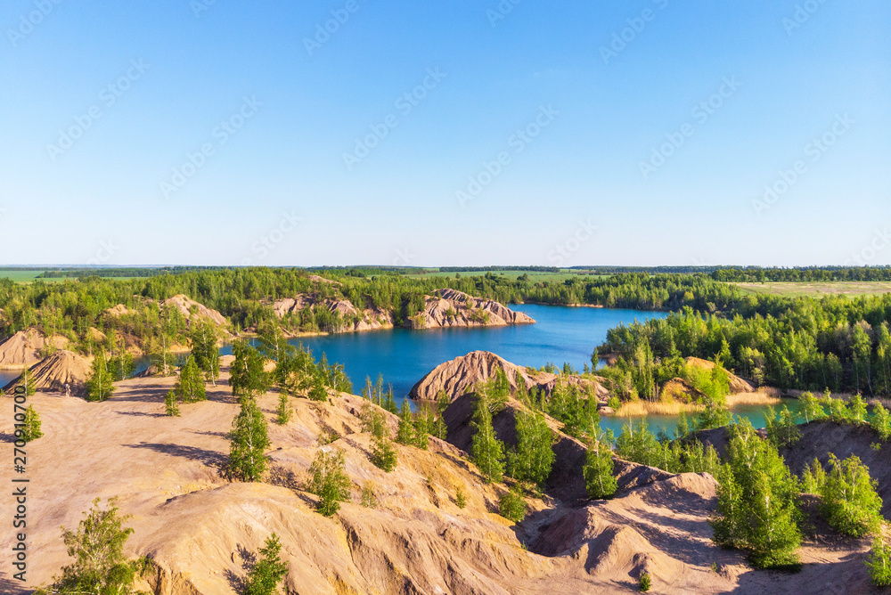 Aerial view of picturesque hills and blue lakes in Konduki, Tula region, Russia. Turquoise quarry in Romantsevo.