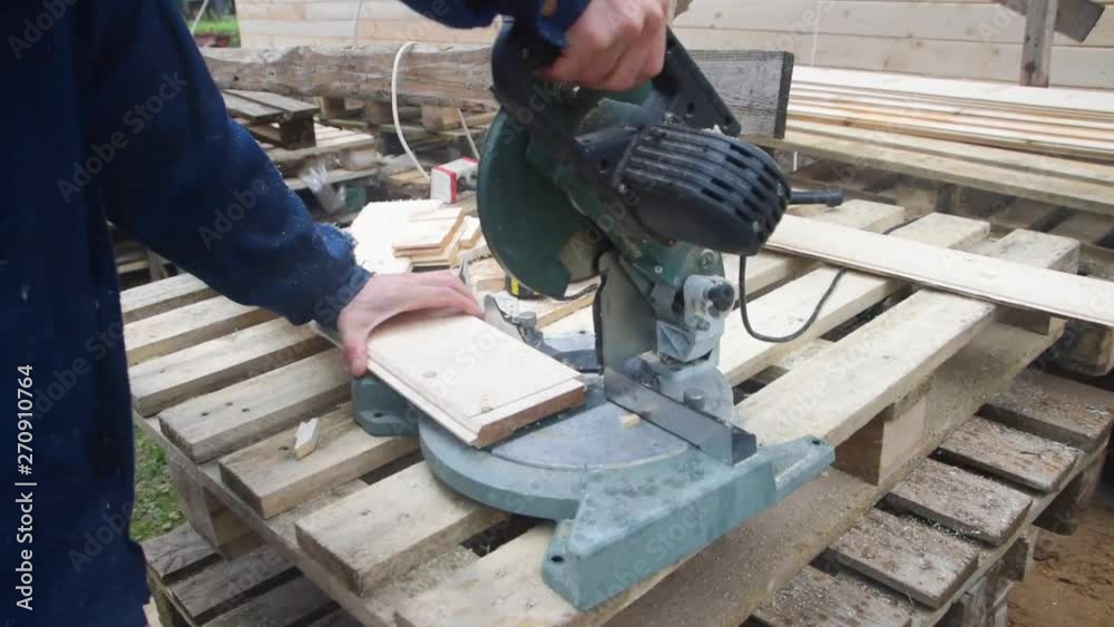 the carpenter man working with electric saw on wood the carpenter man working with electric saw on wood