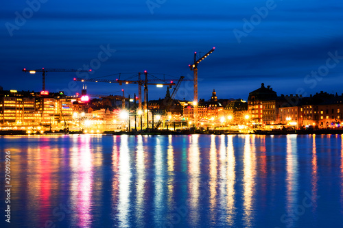 View of Gamla Stan in Stockholm, Sweden with construction cranes during the night