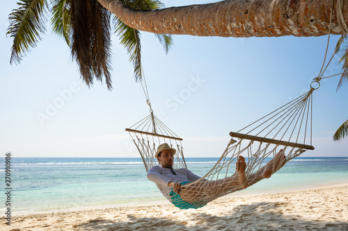 Man Lying On Hammock At Beach