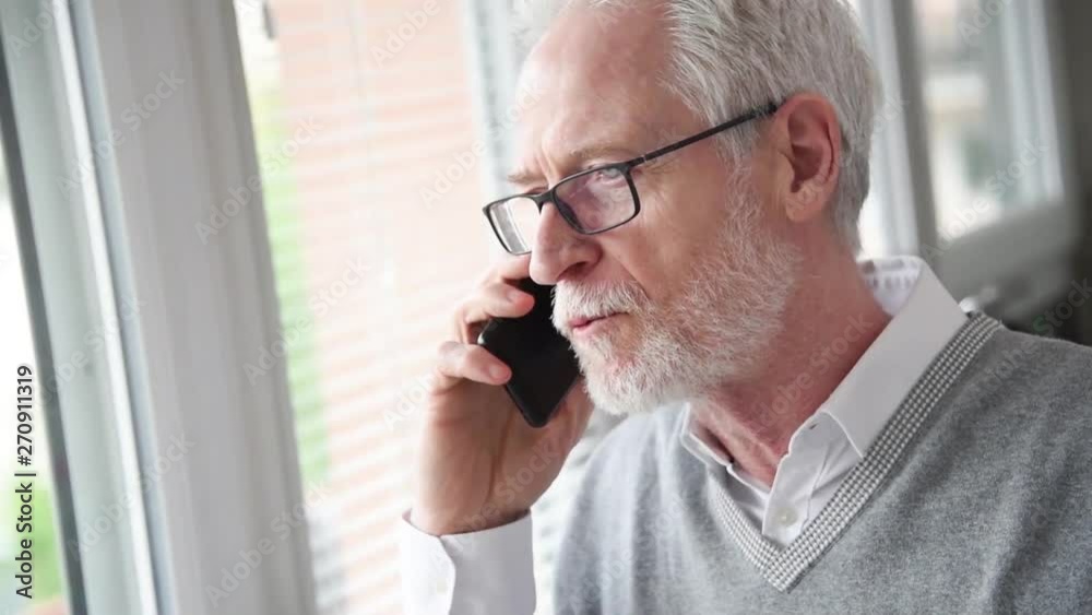 Senior businessman talking on mobile phone Senior businessman talking on mobile phone