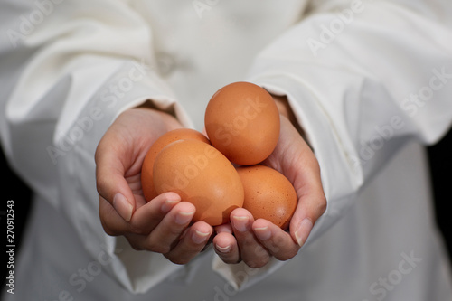 Chef Hand Holding Close UP of Brown Eggs in Studio © Duvy   McGirr