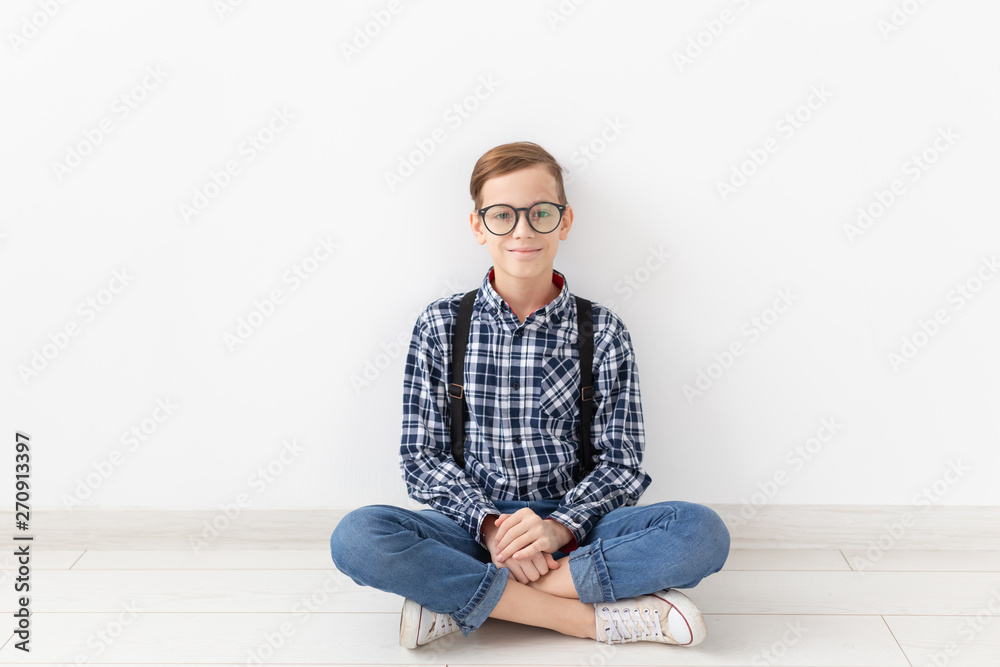 teenager, children and fashion concept - Funny boy with glasses and shirt suspenders