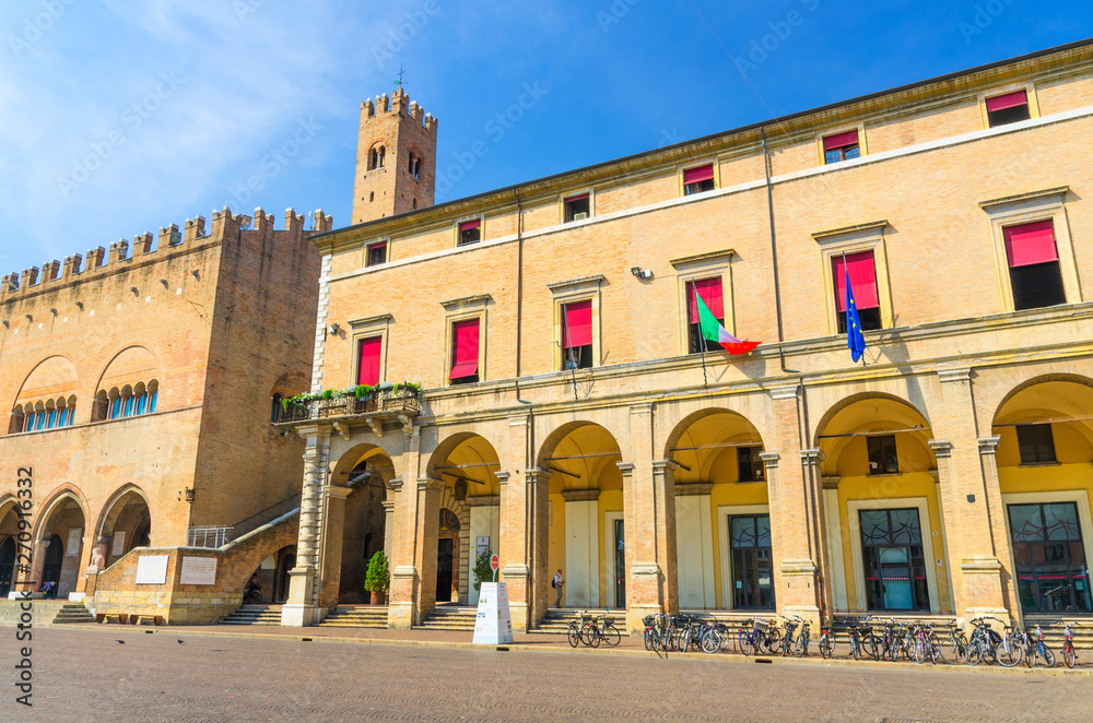 Palazzo Garampi palace building with arches on Piazza Cavour square in old historical touristic city centre Rimini with blue sky background, Emilia-Romagna, Italy