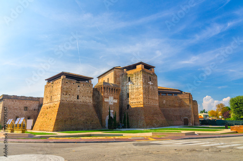 Castel Sismondo brick castle with tower on Piazza Malatesta square in old historical touristic city centre Rimini with blue sky background, Emilia-Romagna, Italy