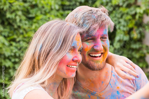 Festival holi  people concept - young couple taking selfie in colourful dirty clothes