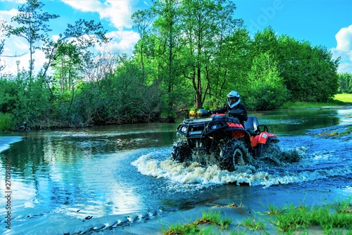 Outdoor activity. Quad bike rides. Extreme sport. Nature, forest, river.