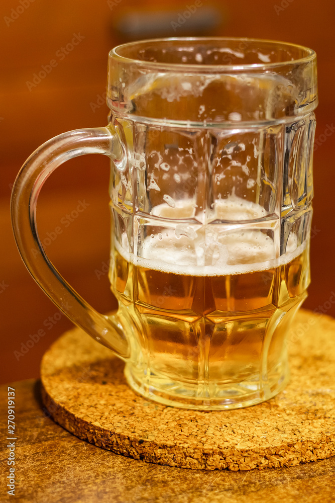 mug beer half on a wooden stand on a blurred background holiday holiday drink hop mug beer half on a wooden stand on a blurred background holiday holiday drink hop