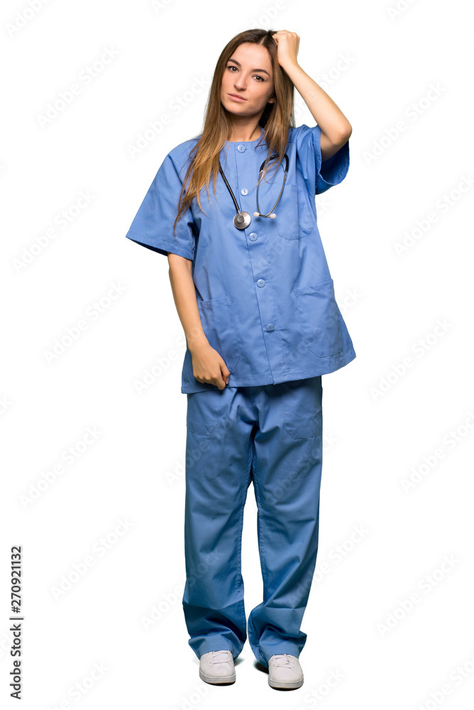 Full body Young nurse with an expression of frustration and not understanding on isolated background Full body Young nurse with an expression of frustration and not understanding on isolated background