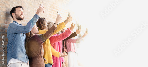 Photos Group of young people making selfies, each with its respective smartphone